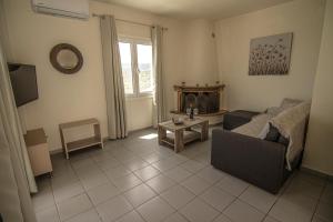 a living room with a couch and a table at Castri Village Hotel in Palekastron