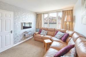 a living room with a couch and a television at Host & Stay - The Haven in Whitby