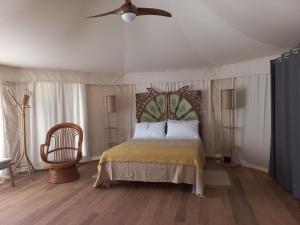 a bedroom with a bed and a ceiling fan at HMO Glamping & Suites in Vignanotica in Mattinata