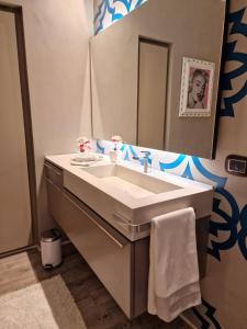 a bathroom with a sink and a mirror at Desenzano Luxury Apartment in Desenzano del Garda