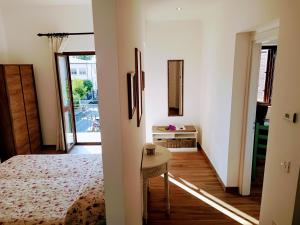 a bedroom with a bed and a table in a room at Appartamento Cavaliere Tropea in Tropea