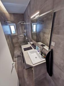 a bathroom with a sink and a mirror at Ikarus Modern Apartment at the Centre of Athens in Athens