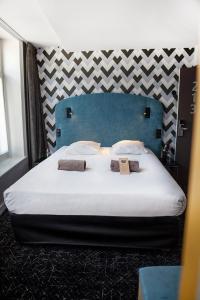 Postel nebo postele na pokoji v ubytování Hotel Kanaï