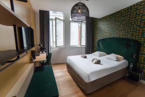 Postel nebo postele na pokoji v ubytování Hotel Kanaï