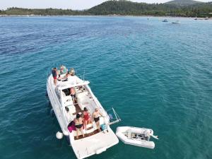 a group of people on a boat in the water at White Eagle Cruises Sani Beach in Sani Beach