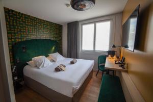 Postel nebo postele na pokoji v ubytování Hotel Kanaï