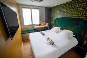 Postel nebo postele na pokoji v ubytování Hotel Kanaï