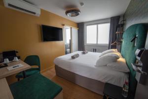 Postel nebo postele na pokoji v ubytování Hotel Kanaï