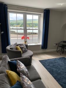 a living room with two couches and a large window at Seaview Aurora House - Central Luxury Apartment in Warrenpoint