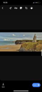 a screenshot of a cell phone screen with a picture of a beach at 20 Holiday Cottage, East End Ballybunion in Ballybunion