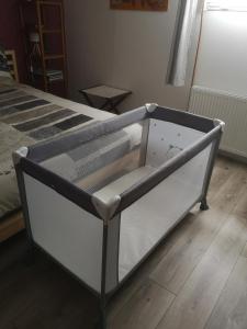 a bed frame with a drawer on the floor at LE CEDRE BLEU in Saint-Michel-sur-Meurthe