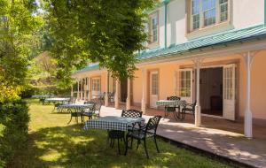 a group of tables and chairs outside of a building at The Dixcart Hotel in Sark