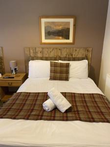a bed with two pillows on top of it at Number 19 Guest House - Room Only in Dalton in Furness