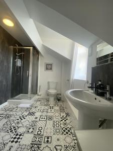 a bathroom with a sink and a shower and a toilet at Number 19 Guest House - 4 miles from Barrow in Furness - 1 mile from Safari Zoo in Dalton in Furness