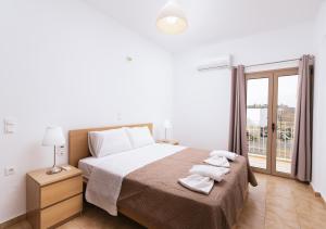 A bed or beds in a room at Halkidio House