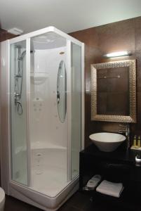 a bathroom with a shower and a sink at Aion Luxury Hotel in Nafplio +48 photos