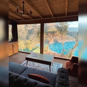 a living room with a couch and a table at Kabak Ütopya Suites in Faralya