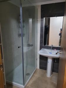 a bathroom with a shower and a sink at Lovely holiday apartment at 8mn walk from beach for families in Cabo Negro