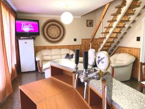 a living room with a staircase and a tv at Holiday home in Szantod - Balaton 20220 in Szántód