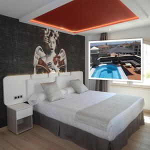 1 dormitorio con 1 cama grande y una pintura en la pared en Hostal Boutique Doña Carmen - Adults Recommended, en Nerja
