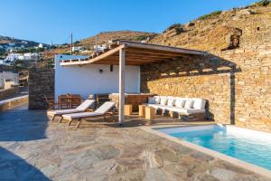 a villa with a swimming pool and a house at villaV in Triandáros