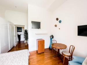 a living room with a table and a couch at I Love Mergellina in Naples