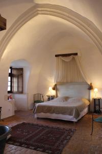 a bedroom with a large bed with a canopy at Chateau de Forges in Concremiers