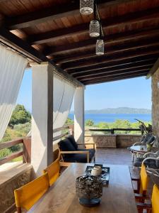 a dining room with a table and a view of the ocean at STONEHOUSE & CASA AL SOLE e AL MARE in Nea Roda