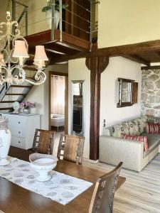 a living room with a table and a couch at STONEHOUSE & CASA AL SOLE e AL MARE in Nea Roda