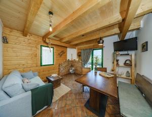 a living room with a couch and a table at Holiday Park Plitvice Paradise in Korenica