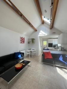 a living room with a couch and a table at The Cottage at No. 3 in West Lavington