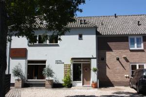 a white building with a door in front of it at Maison Bellefleur B&B - Pension in Renesse