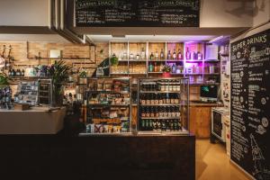 a store with a counter with bottles of alcohol at Superbude Hamburg St Georg in Hamburg