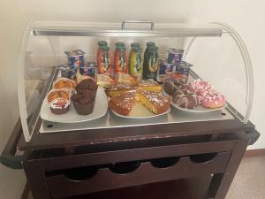 a refrigerator filled with different types of pastries and drinks at B&B A due passi dal Lago in Adro