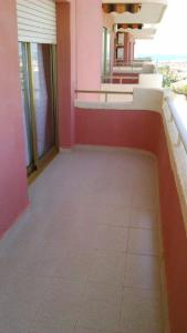 an empty hallway of a building with pink walls at Apart Rubi II Vv in La Manga del Mar Menor