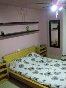 1 dormitorio con cama y espejo en la pared en Apart Rubi II Vv, en La Manga del Mar Menor