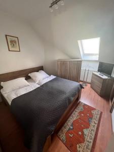 a bedroom with a bed with a rug and a window at Kisvölgy House in Eger