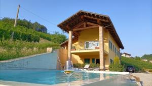 a glass of wine sitting on top of a swimming pool at Sogno in Langa in Monforte dʼAlba