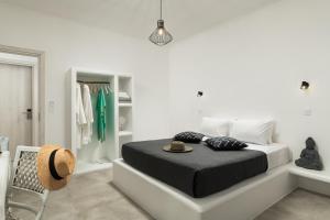 a bedroom with a bed with a hat on it at Island Concept Chania in Agia Marina Nea Kydonias