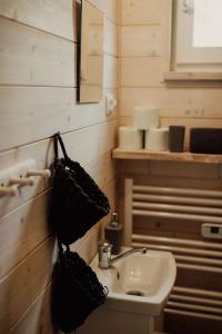 a bathroom with a sink and a mirror and a toilet at Domki Kacprowy w Lipnicy in Lipnica