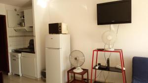 ラ・グランド・モットにあるResidence Acapulcoの冷蔵庫、壁掛けテレビが備わる客室です。