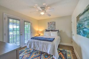 EatontonLakefront Home with Entertainment Space and Dock!的带床和吊扇的卧室