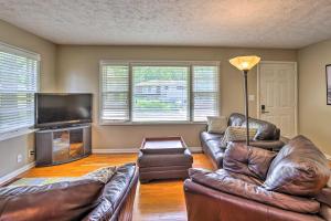 a living room with leather furniture and a flat screen tv at Family-Friendly Omaha Home about 5 Mi to Dtwn! in Omaha