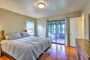 a bedroom with a bed and a sliding glass door at Family-Friendly Omaha Home about 5 Mi to Dtwn! in Omaha