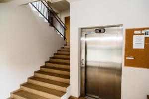 a elevator in a building with a staircase at Hazel Apartment in Vilnius