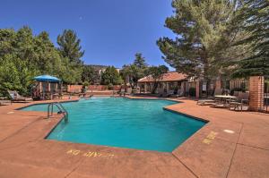 a swimming pool in a yard with a table and chairs at Bright Sedona Condo Resort-Style Amenities! in Sedona
