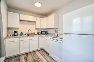 a kitchen with white cabinets and white appliances at Pet-Friendly Pad about 3 Mi to Dtwn Knoxville! in Knoxville