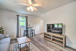 a living room with a couch and a flat screen tv at Pet-Friendly Pad about 3 Mi to Dtwn Knoxville! in Knoxville