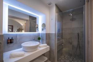 a bathroom with a large sink and a shower at Eleven, Boutique luxury house & garden in Boliqueime