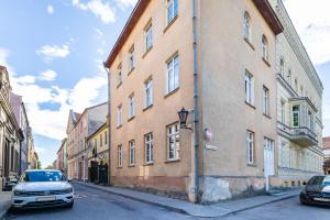 a car parked in front of a building on a street at Old Town Hearh Light and Open Modern Flat VIP in Klaipėda
